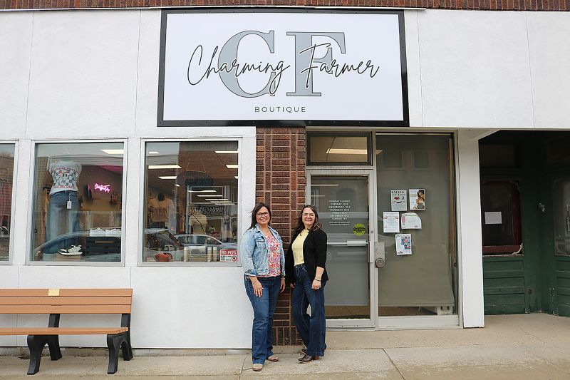 Amanda Heibel, left, and Becky Jones stand outside their new store in Harmony, Minn., called Charming Farmer Boutique.
