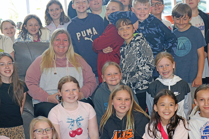 The smiles on their faces show how happy Ms. Graves’ students are for her to be named Teacher of the Year. Photo by Barb Jeffers