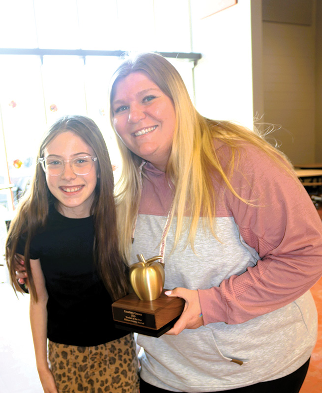 On the left, Courtney Graves is congratulated by fellow teacher Dave Rogers. On the right, Ms. Graves poses for a photo with student Evelyn Ehler. Photo by Barb Jeffers