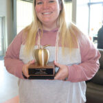 Courtney Graves holds her Golden Apple Award presented to Teacher of the Year. Photo by Barb Jeffers
